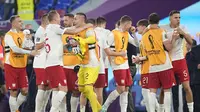 Reaksi gembira para pemain Polandia setelah lolos ke babak 16 besar Piala Dunia 2022 meski kalah dengan skor 0-2 dari Argentina pada matchday ketiga Grup C yang berlangsung di Stadion 974, Doha, Kamis (01/12/2022). (AP/Ariel Schalit)