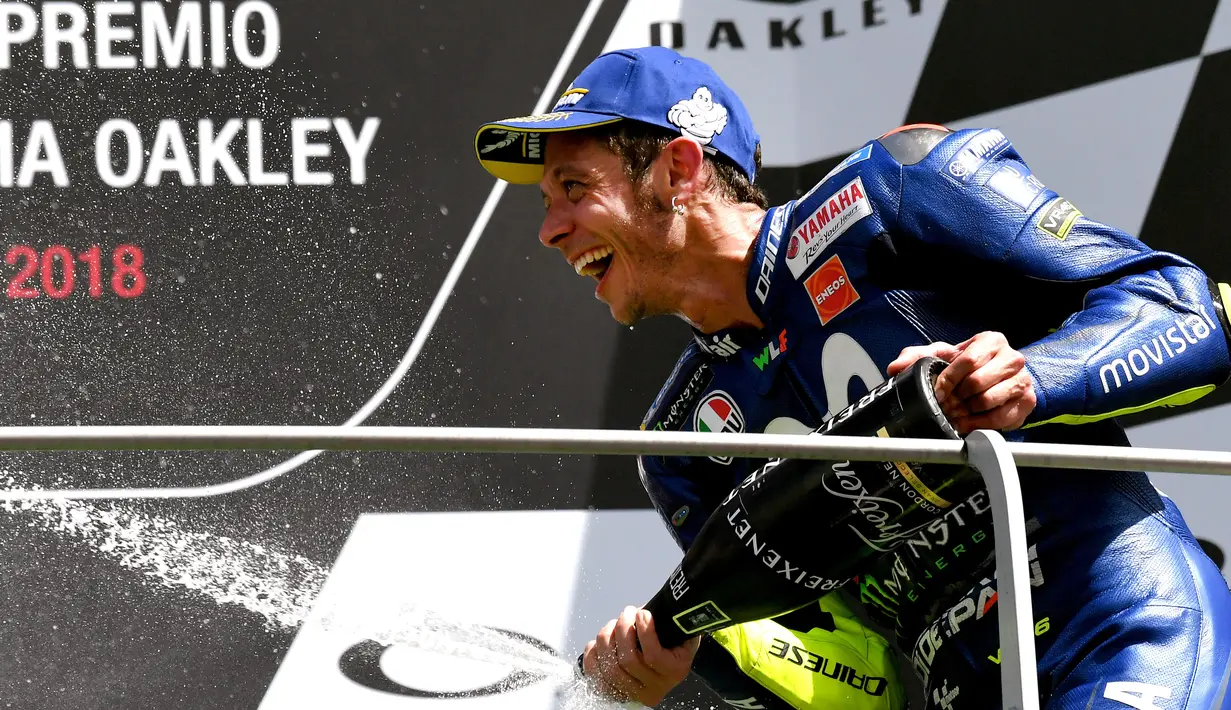 Pembalap Italia Movistar Yamaha, Valentino Rossi merayakan selebrasi di podium setelah memenangkan di posisi ketiga Moto Grand Prix di Sirkuit Mugello, Italia, Minggu (03/6). (AFP FOTO / Tiziana Fabi)