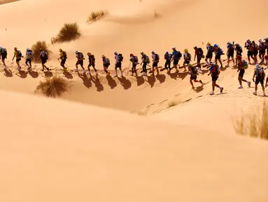 Peserta mendaki gurun Sahara saat mengambil bagian dalam kejuaraan marathon des Sables di Maroko Selatan, (10/4). Peserta akan menempuh jarak sekitar 257 kilometer melintasi panasnya gurun Sahara. (AFP PHOTO/JEAN-PHILIPPE Ksiazek)