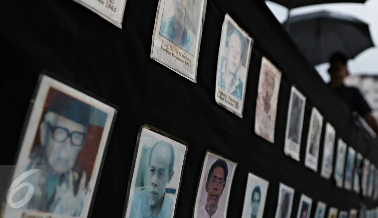 Aktivis JSKK membawa foto korban HAM saat aksi Kamisan ke-467, Jakarta, Kamis (10/11). Bertepatan Hari Pahlawan, JSKK kembali meminta kepada Presiden Jokowi agar segera menuntaskan kasus pelanggaran HAM berat masa lalu. (Liputan6.com/Immanuel Antonius)