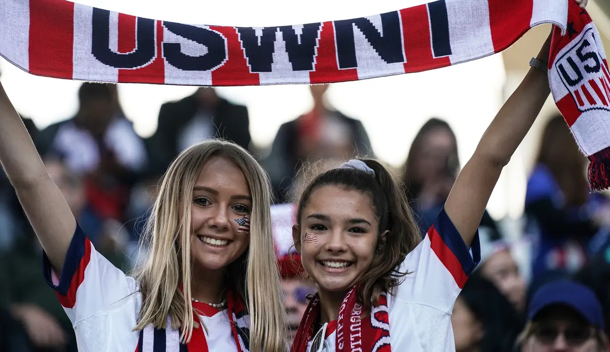 Dua fans wanita AS membentangkan syal sebelum pertandingan Grup F Piala Dunia Wanita 2019 antara Amerika Serikat melawan Thailand di Stadion Auguste-Delaune di Reims, Prancis (11/6/2019). (AFP Photo/Lionel Bonaventure)