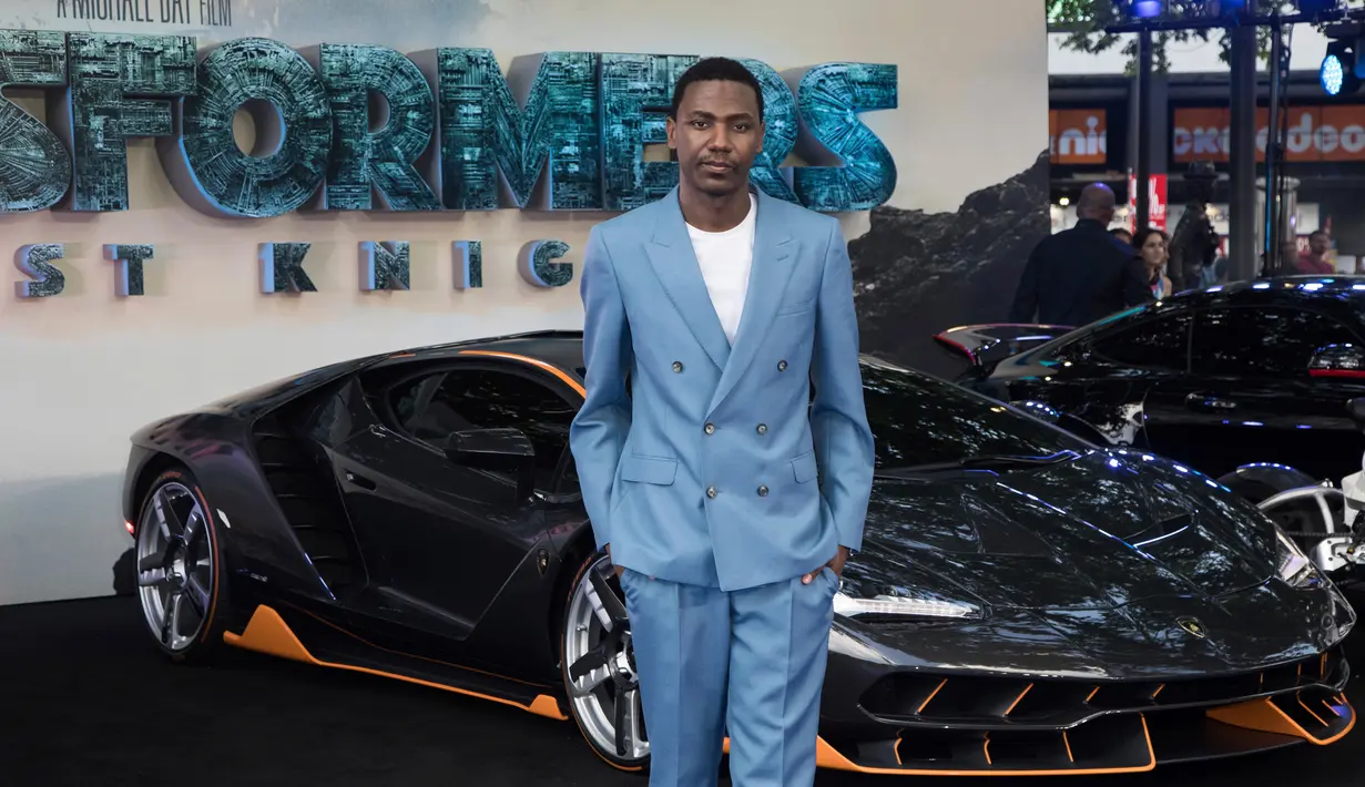 Jerrod Carmichael berpose didepan mobil Lamborghini Centenario saat pemutaran perdana film 'Transformers, The Last Knight' di London (18/6). Mobil ini dijual seharga US$1,9 juta atau Rp25,3 miliar. (Vianney Le Caer/AP Images for Automobili Lamborghini)
