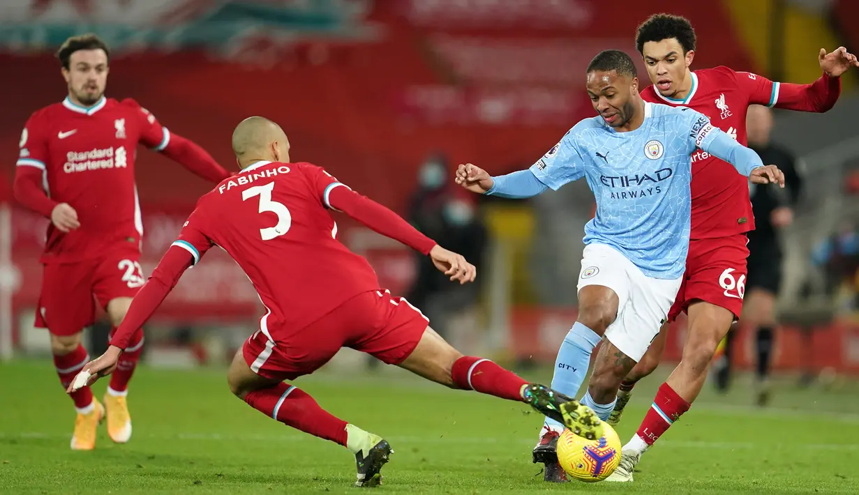 Gelandang Manchester City, Raheem Sterling (tengah) dikepung dua pemain Liverpool, Fabinho (kiri) dan Trent Alexander-Arnold dalam laga lanjutan Liga Inggris 2020/21 pekan ke-23 di Anfield Stadium, Minggu (7/2/2021). Manchester City menang 4-1 atas Liverpool. (AFP/Jon Super/Pool)