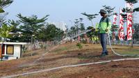Salah satu petugas melakukan penyiraman taman di area RTH/RPTRA Kalijodo, Jakarta. Selasa (24/7). Sebelumnya, warganet ramai membahas di media sosial ihwal kondisi RTH dan RPTRA Kalijodo yang terlihat terbengkalai. (Liputan6.com/Helmi Fithriansyah)