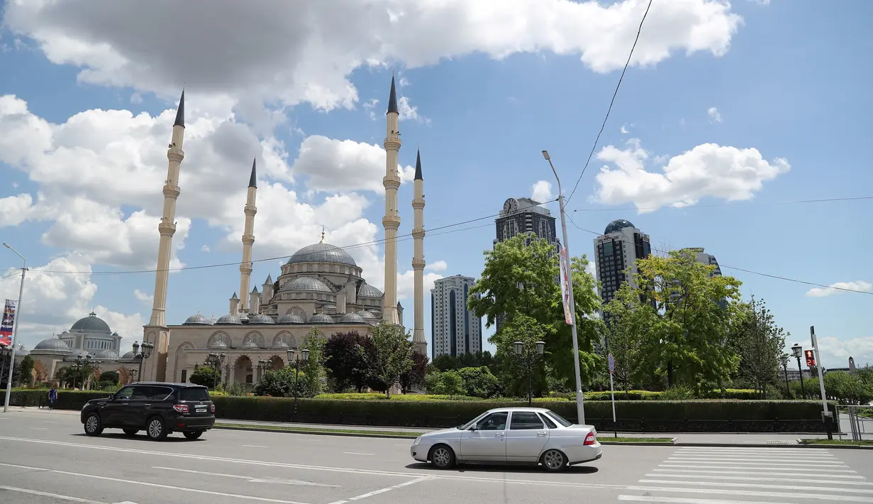 Kendaraan melintasi Masjid Akhmad Kadyrov di alun-alun Kota Grozny, pusat ibu kota Chechnya, 9 Juni 2018. Saking besarnya, masjid ini mampu menampung sekitar 10.000 jemaah dengan desain interior yang sangat menakjubkan. (AFP PHOTO/KARIM JAAFAR)