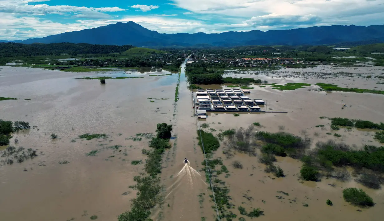 Hujan deras yang mengubah jalan menjadi sungai. (MAURO PIMENTEL/AFP)