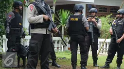 Petugas kepolisian Brimob Polda Metro Jaya mengerahkan anjing pelacak serta menyisir area tempat kejadian perkara (TKP) penggerebekan terduga teroris di setu, Tangerang Selatan, Banten, Rabu (21/12). (Liputan6.com/Helmi Affandi)