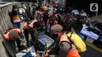 Aparat gabungan mengangkut dagangan pedagang yang berjualan di trotoar di kawasan Tanah Abang, Jakarta, Minggu (2/5/2021). Selain merazia barang dagangan pedagang, aparat gabungan juga menegur warga yang tidak menerapkan protokol kesehatan. (Liputan6.com/Johan Tallo)