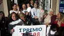 Penjual tiket undian dan pemenang merayakan kemenangan di sebuah toko lotre di Malaga, Spanyol (22/12). Natal tahun ini memberi keceriaan buat karyawan Sagrado Corazon di Campo de Criptana, Spanyol. (AFP Photo/Jorge Guerrero)