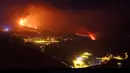 Lava dari gunung berapi mencapai laut di pulau Canary La Palma, Spanyol, Rabu (29/9/2021) dinihari. Lava merah panas dari gunung berapi Cumbre Vieja mencapai Samudra Atlantik, sembilan hari setelah mulai mengalir menuruni gunung. (AP Photo/Daniel Roca)