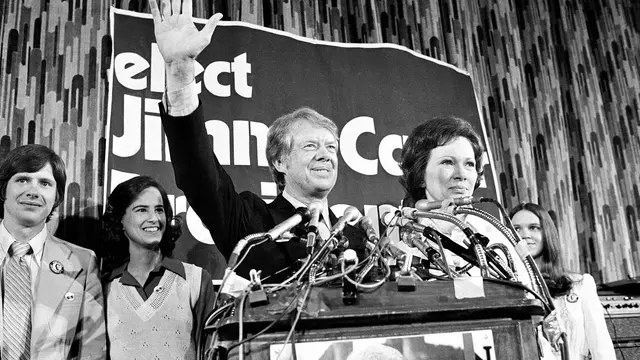 Jimmy Carter dan istrinya, Rosalynn, melambaikan tangan kepada para pendukungnya di Philadelphia saat ia mengklaim kemenangan dalam pemilihan pendahuluan Pennsylvania, April 1976. (Paul Vathis/AP)