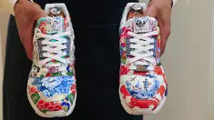 Pekerja memegang sepatu kets unik kolaborasi Adidas dan produsen porselen Meisse bernama Porcelain ZX8000, saat pratinjau di rumah lelang Sotheby di New York City pada 4 Desember 2020. Sepatu yang akan dilelang bulan ini diperkirakan terjual dengan nilai hingga 1 juta dollar AS. (Kena Betancur/AFP)