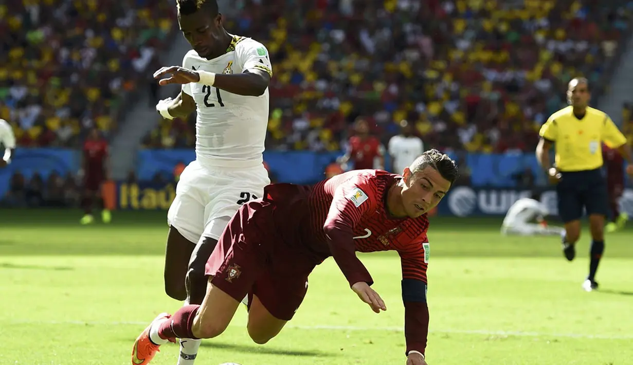 Penyerang Timnas Portugal, Cristiano Ronaldo (kanan) terjungkal saat mencoba lolos dari hadangan John Boye (Ghana) di laga penutup penyisihan Piala Dunia 2014 Grup G di Stadion Nasional Brasilia, (26/6/2014). (REUTERS/Dylan Martinez)