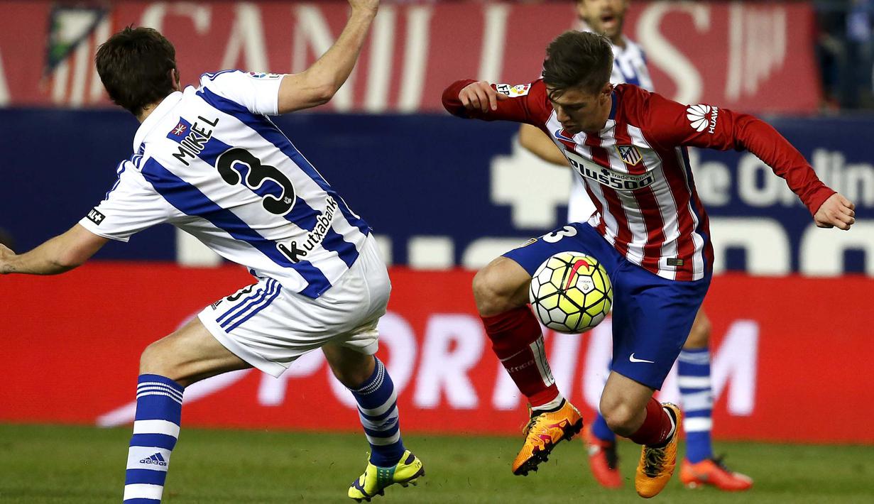 Pemain Atletico Madrid, Luciano Vietto (kanan) berusaha melewati pemain Real Sociedad, Mikel Gonzalez pada lanjutan La Liga di Vicente Calderon, Madrid, Rabu (2/3/2016) dini hari WIB. (REUTERS/Juan Medina)