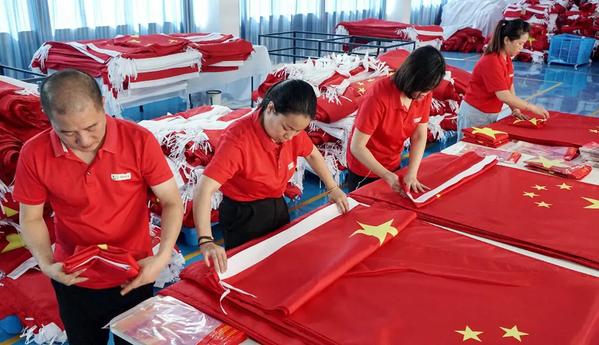 Para pekerja membuat bendera nasional di sebuah pabrik menjelang Hari Nasional di Wuyi, Provinsi Zhejiang, China, 28 September 2021. Hari Nasional adalah sebuah hari libur nasional di China untuk merayakan hari kebangsaan mereka dan diperingati pada tanggal 1 Oktober setiap tahun. (STR/AFP)