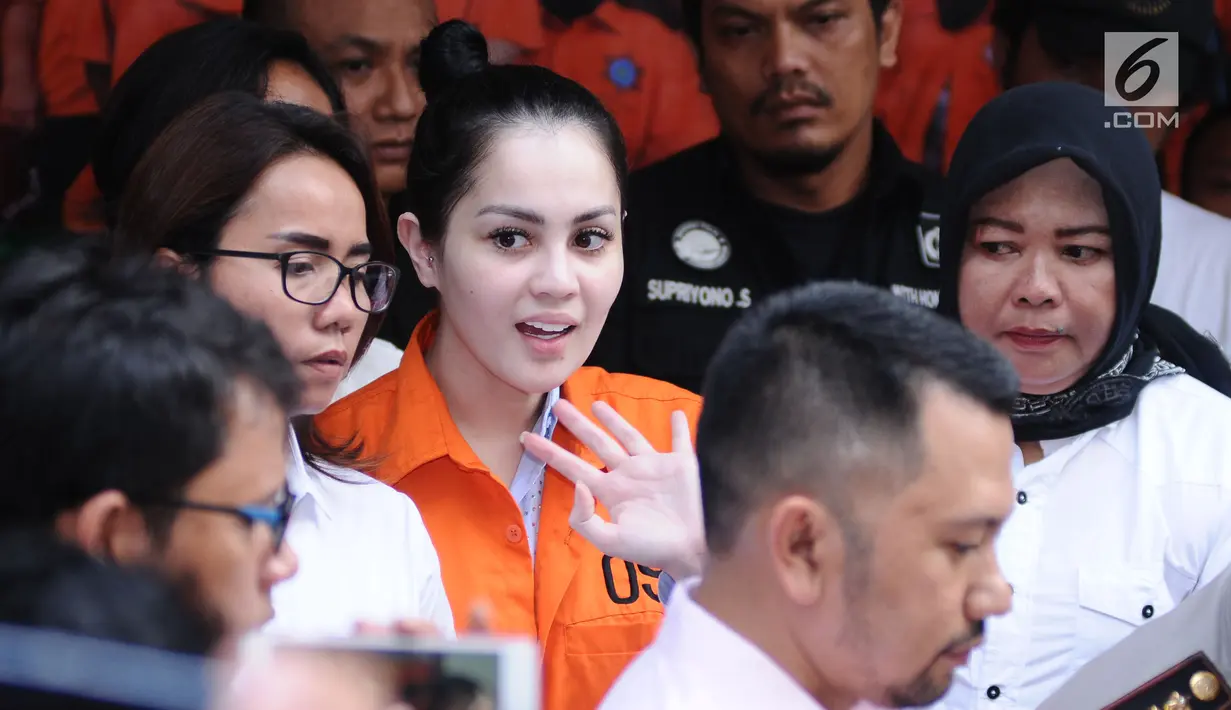 Artis peran dan model, Jennifer Dunn melambaikan tangan saat diperlihatkan usai penangkapan di Dirnarkoba Polda Metro Jaya, Jakarta, Selasa (2/1). Polisi menyita 0,6 gram sabu dan sejumlah telepon genggam. (Liputan6.com/Helmi Fithriansyah)
