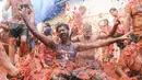 Orang-orang yang bersuka ria saling melempar tomat dalam acara tahunan "Tomatina", pesta pertarungan tomat di desa Bunol dekat Valencia, Spanyol, Rabu (31/8/2022). La Tomatina sering dianggap sebagai salah satu pertarungan makanan terbesar di dunia. (AP Photo/Alberto Saiz)