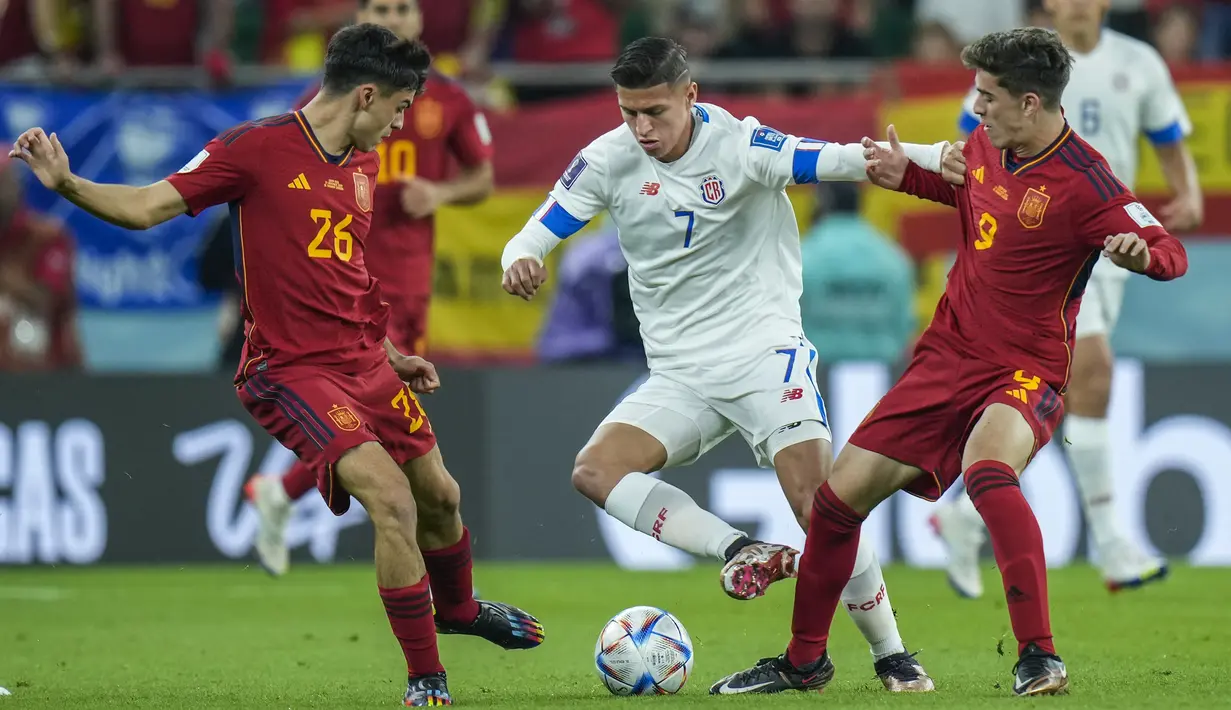 <p>Gelandang Kosta Rika, Anthony Contreras (tengah) berusaha melewati dua pemain Spanyol, Gavi dan Pedri pada pertandingan grup E Piala Dunia 2022 Qatar di Stadion Al Thumama di Doha, Qatar, Rabu (23/11/2022). Spanyol menang atas Kosta Rika dengan skor. (AP Photo/Francisco Seco)</p>