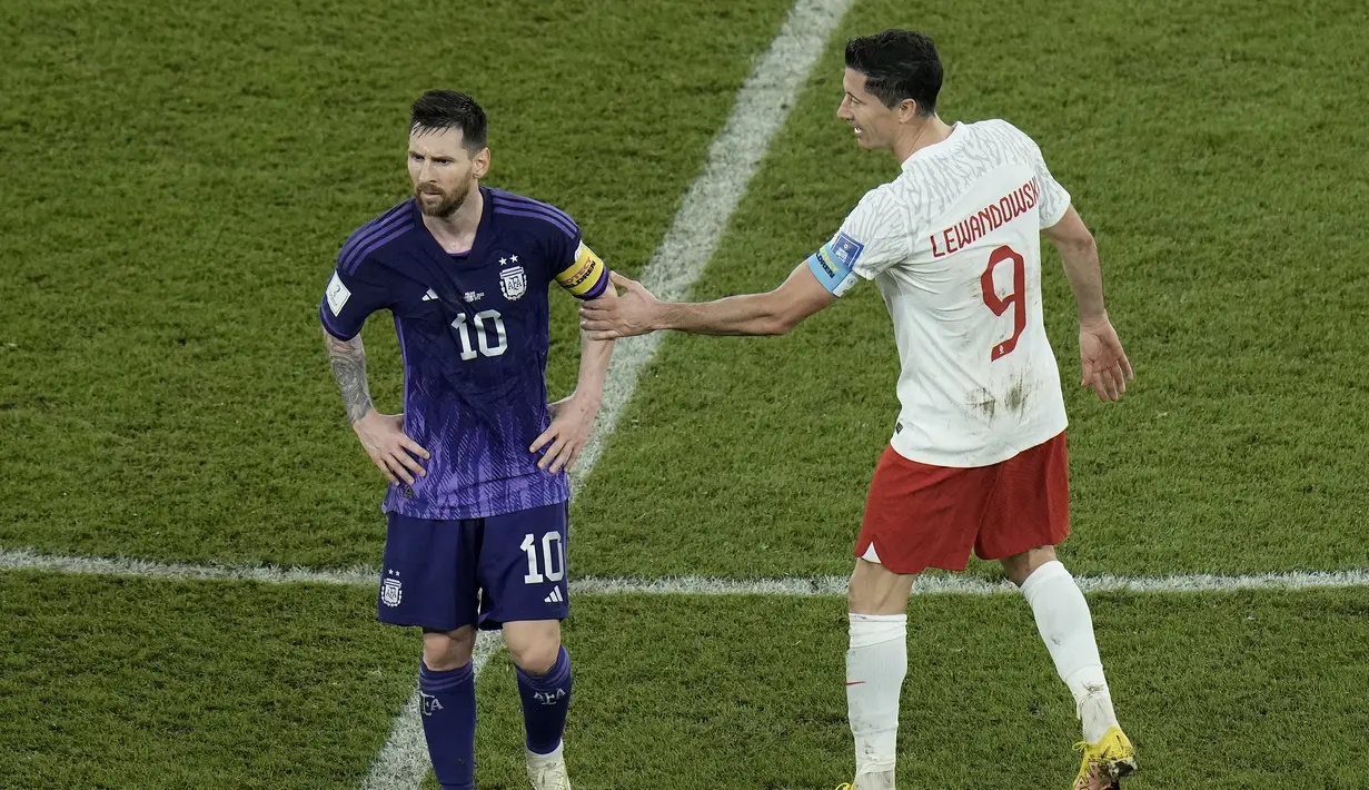 Seusai laga yang berkseudahan 2-0 untuk kemenangan Argentina yang sekaligus meloloskan keduanya ke babak 16 besar, Robert Lewandowski menghampiri Lionel Messi untuk memberikan selamat. (AP/Hassan Ammar)
