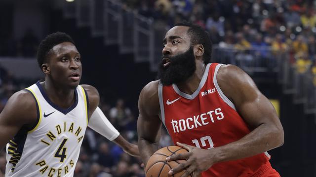 Aksi Bintang Rockets James Harden berduel dengan Victor Oladipo pada lanjutan NBA (AP)