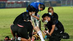 Sejumlah petugas tampak sigap memberikan bantuan kepada Kiper Bali United, Wawan Hendrawan, yang terkapar usai laga melawan Persib Bandung di laga BRI Liga 1 di Stadion Indomilk Arena. (Bola.com/M Iqbal Ichsan)