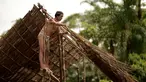Penduduk asli Waorani, Tiri Nenquimo, membangun rumah tradisional di desa Nemompare, di tepi sungai Curaray, di provinsi Pastaza, Ekuador (14/4/2019). Suku Waorani dari Amazon Ekuador berdemo di depan pengadilan memprotes perusahaan minyak keluar dari wilayah mereka. (AFP Photo/Rodrigo Beundia)
