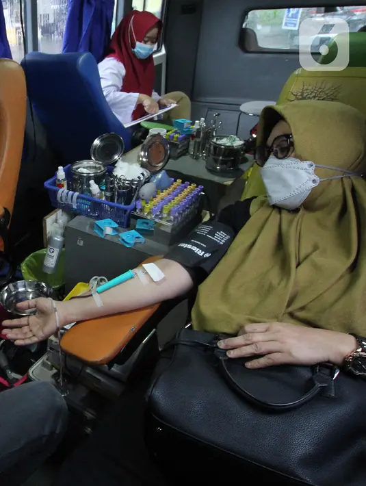 Warga melakukan donor darah saat Ramadan dalam mobil milik PMI Kota Tangerang, Banten, Kamis (15/4/2021). Donor darah dalam mobil tersebut dilakukan PMI untuk menarik minat masyarakat agar mendonorkan darah dan dapat menjaga stok darah aman selama bulan puasa. (Liputan6.com/Angga Yuniar)