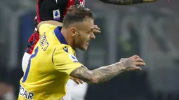 Bek AC Milan Davide Calabria dan bek Hellas Verona, Federico Dimarco melompat saat berebut bola pada lanjutan Liga Italia Serie A di San Siro, Senin (9/11/2020) dinihari WIB. AC Milan harus puas berbagi angka dengan Hellas Verona setelah bermain imbang 2-2. (AP Photo/Antonio Calanni)