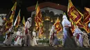 Warga mengenakan pakaian tradisional dan membawa bendera nasional pada Festival Navam Perahera di Kolombo, Sri Lanka, 15 Februari 2022. Biksu, penari, pemusik, dan lainnya berpartisipasi dalam perayaan di Kuil Gangaramaya yang terkenal. (AP Photo/Eranga Jayawardena)