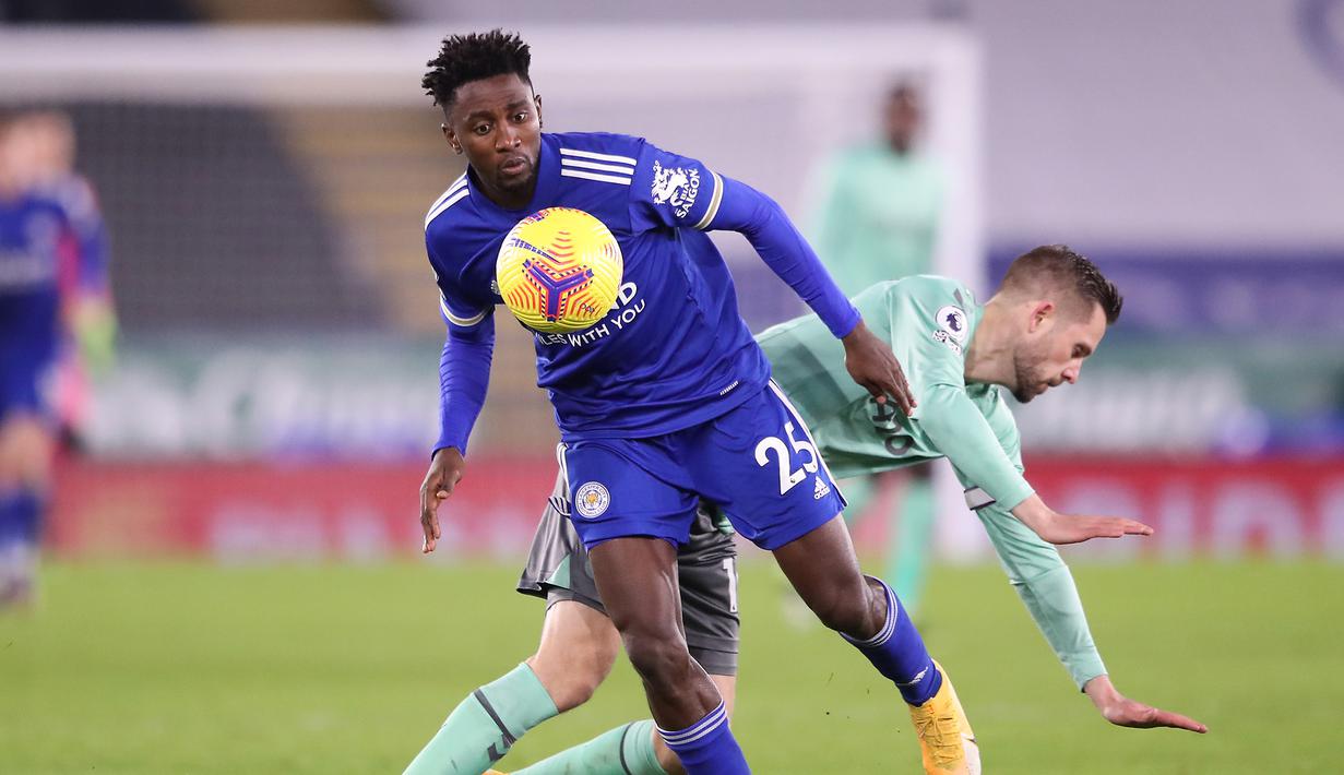 Gelandang Everton, Gylfi Sigurdsson, berebut bola dengan gelandang Leicester City, Wilfred Ndidi, pada laga lanjutan Liga Inggris di King Power Stadium, Kamis (17/12/2020) dini hari WIB. Everton menang 2-0 atas Leicester City. (AFP/Alex Pantling/pool)
