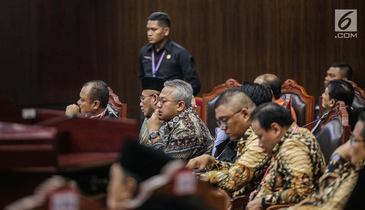 Ekpresi Ketua KPU Arief Budiman (tengah) saat mengikuti sidang putusan sengketa Pilpres 2019 di Gedung Mahkamah Konstitusi (MK), Jakarta, Kamis (27/6/2019). MK akan membacakan putusan sengketa Pilpres 2019 yang dimohonkan kubu Prabowo-Sandiaga. (Liputan6.com/Faizal Fanani)