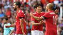 Legenda Manchester United, Ji-sung Park dan Danny Webber merayakan kemenangan saat bertanding melawan Legenda Barcelona di Stadion Old Trafford, Sabtu (2/9/2017). Pertandingan tersebut merupakan laga amal. (AFP/Paul Ellis)