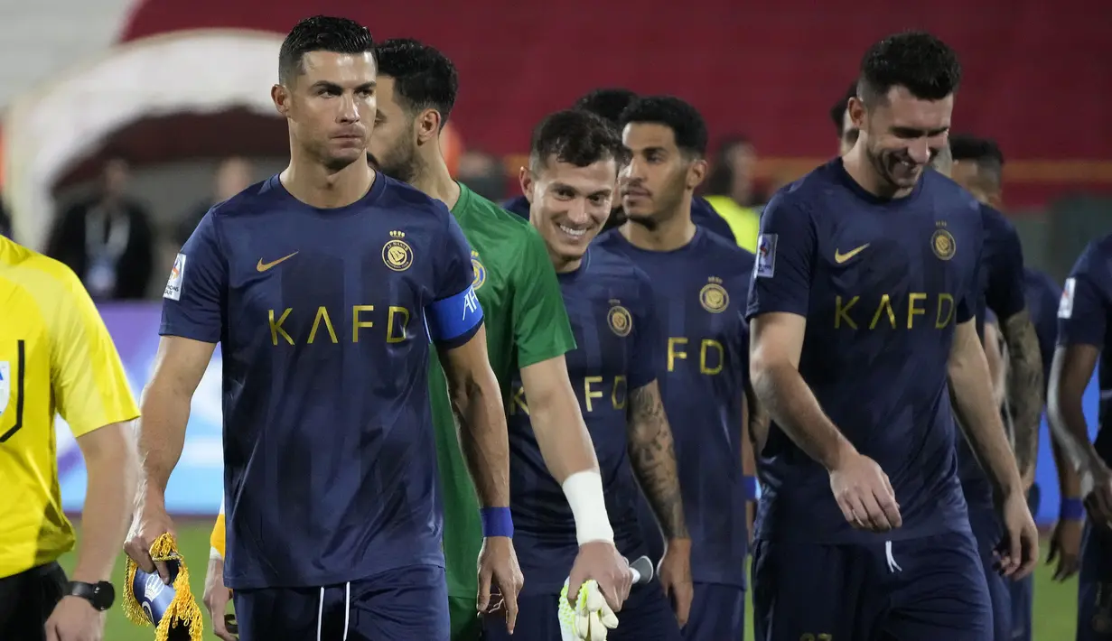 Pemain Al-Nassr, Cristiano Ronaldo berjalan memimpin rekan-rekannya saat laga Grup E Liga Champions Asia 2023/2024 melawan Persepolis yang berlangsung di Azadi stadium, Teheran, Iran, 19 September 2023. (AP Photo/Vahid Salemi)