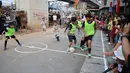 Anak-anak mengikuti pertandingan Turnamen Sepak Bola Liga Aspal U-13 di kawasan permukiman padat di pinggir rel RT 09/RW 08, Menteng Jaya, Jakarta, Senin (29/6/2026). (merdeka.com/ Arie Basuki)