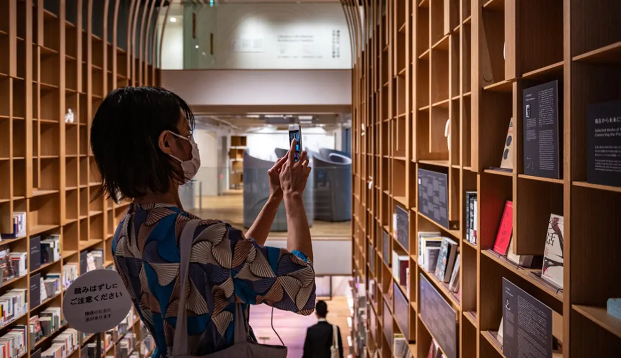Reporter mengambil gambar dalam Rumah Sastra Internasional Waseda di Universitas Waseda, Tokyo, Jepang, 22 September 2021. Rumah Sastra Internasional Waseda yang juga dikenal sebagai Perpustakaan Haruki Murakami dirancang oleh arsitek Jepang, Kengo Kuma. (Philip FONG/AFP)