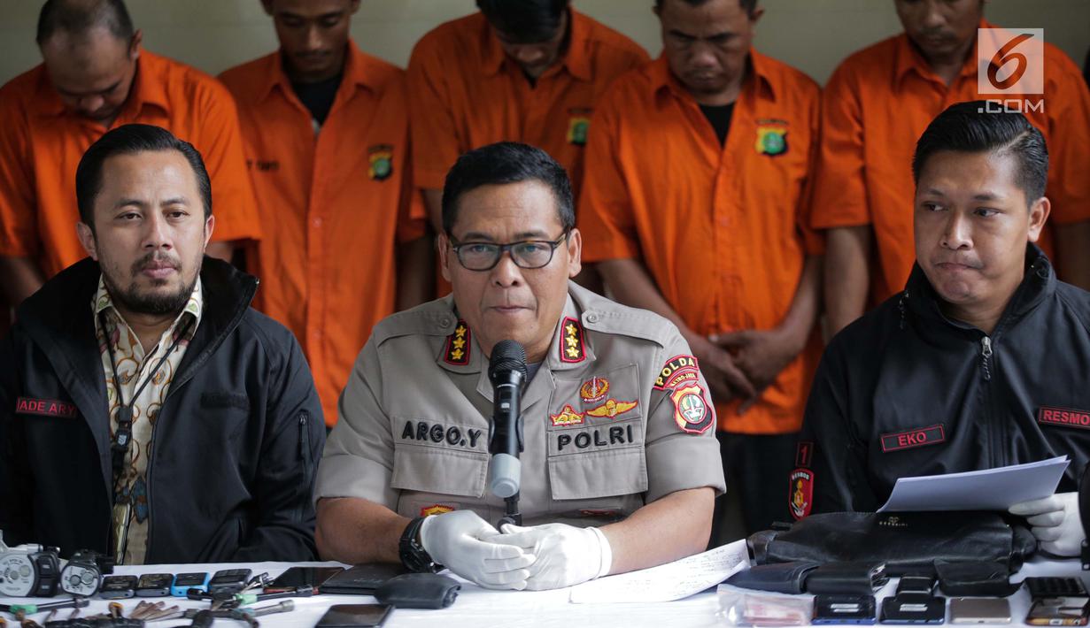 Kabid Humas Polda Metro Jaya, Kombes Pol Argo Yuwono dan Wadir Reskrimum Polda Metro Jaya AKBP Ade Ary Syam saat merilis pengungkapan beberapa kasus di Subdit Resmob Polda Metro Jaya, Jakarta, Jumat (19/7/2019). Sebanyak 9 kasus dirilis oleh Subdit Resmob Polda Metro Jaya.(Liputan6.com/Faizal Fanani