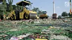 Ribuan botol minuman keras (miras) ilegal dihancurkan dengan menggunakan alat berat di Lapangan Silang Monas Tenggara, Jakarta, Senin (27/5/2019). Pemprov DKI memusnahkan 18.174 botol miras tanpa izin hasil penertiban periode Januari 2019 hingga Mei 2019. (merdeka.com/Iqbal S Nugroho)