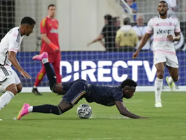 Bek Juventus Danilo (kiri) menjegal penyerang Real Madrid Vinicius Jose Paixao saat mencoba mendapatkan posisi menguasai bola pada laga pramusim di Camping World Stadium, Kamis (3/8/2023) pagi WIB.  (AP Photo/John Raoux)