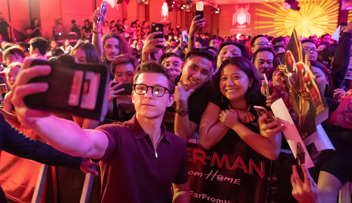 Aktor Tom Holland berswafoto dengan penggemarnya saat acara Spider-Man: Far From Home Pan-Asian Media Summit Bali di Denpasar, Senin (27/5/2019). Kegiatan itu merupakan rangkaian promo film terbaru yang rencananya akan dirilis pada Juli mendatang. (ANTHONY KWAN/GETTY IMAGES NORTH AMERICA/AFP)