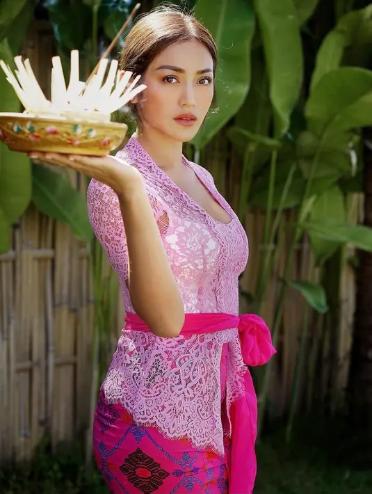 Jessica Iskandar atau Jedar mengenakan kebaya lengan pendek berwarna pink yang dipadukan dengan kamen senada. Sabuk prada pink yang diikat dipinggang membuat penampilannya makin memesona ya. (Instagram/inijedar).
