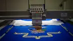 Bendera Departemen Kehakiman Amerika Serikat sedang di bordir di National Capital Flag Company, Alexandria Virginia, AS (10/1). Bendera itu akan digunakan untuk upacara pelantikan presiden baru AS, Donald Trump. (AFP/Andrew Caballero Reynolds)