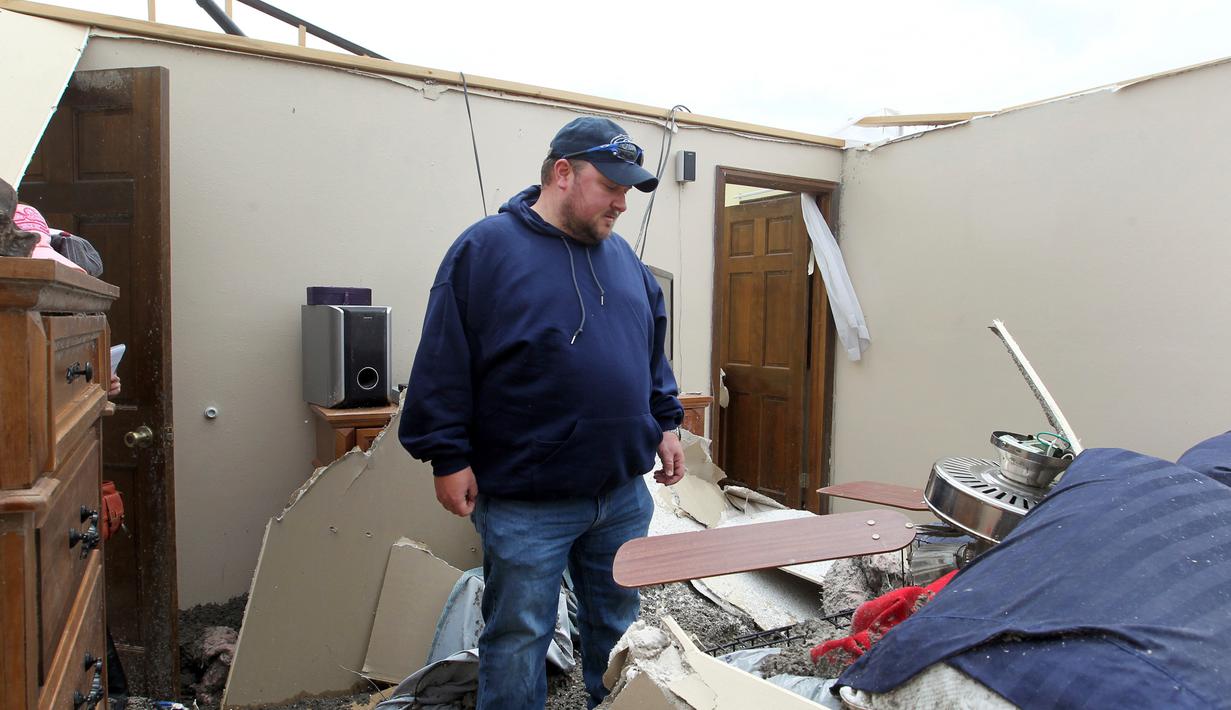 Seorang pria memeriksa barang yang ada dirumahnya usai dilanda tornado di Laramie County, Wyoming, AS (29/5). Usai hantaman tornado tersebut sejauh ini belum ada laporan korban jiwa. (Jacob Byk/The Wyoming Tribune Eagle via AP)
