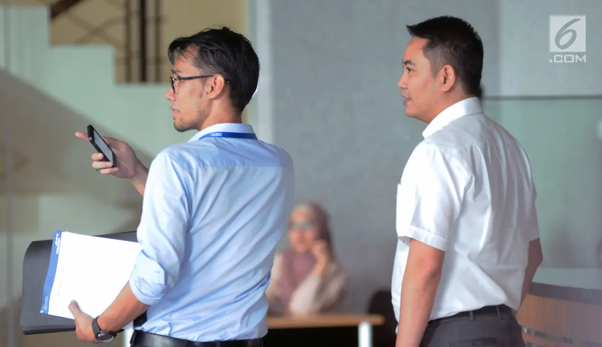 Politisi Partai Golkar, Fayakhun Andriadi (kanan) berbincang jelang meninggalkan Gedung KPK, Jakarta, Rabu (27/12). Fayakhun dimintai keterangan sebagai saksi dugaan suap pengadaan alat satelit monitoring Bakamla-RI. (Liputan6.com/Helmi Fithriansyah)