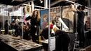 Peserta pameran mempersiapkan stan mereka selama Paris Tattoo Convention di Grand Halle de la Villette, Paris, Prancis, Jumat (9/3). Paris Tattoo Convention berlangsung dari tanggal 9 sampai 11 Maret. (Philippe LOPEZ/AFP)