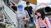 Penumpang turun dari pesawat Malaysia Airlines Boeing 738 setelah mendarat di Langkawi dari Bandara Internasional Kuala Lumpur (16/9/2021). Pulau liburan dibuka kembali untuk turis domestik setelah penutupan karena pembatasan Covid-19. (AFP/Mohd Rasfan)