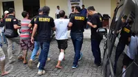 Petugas membawa salah satu komplotan pencuri spesialis rumah kosong saat rilis di Halaman Polrestabes Semarang , Minggu ( 19/6). Menjelang lebaran kejahatan pencurian rumah kosong meningkat. (Gholib)
