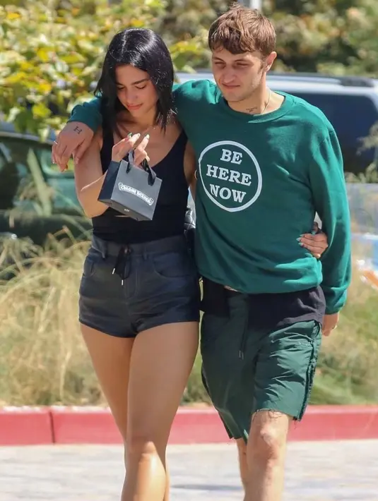 Dengan memakai pakaian minim warna hitam, pelantun lagu 'New Rules' ini terlihat begitu romantis dengan melingkarkan tangan ke tubuh Anwar Hadid. Keduanya terlihat tak ragu lagi untuk pamer kemesraan ke publik. (Liputan6.com/IG/@duadiares2)