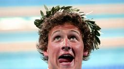 Pada Olimpiade pertamanya di Athena 2004, Ryan Lochte langsung berhasil mempersembahkan medali emas. Lochte yang saat itu masih 20 tahun memenangi nomor beregu 4x200 m gaya bebas. (AFP/Francois Xavier) 