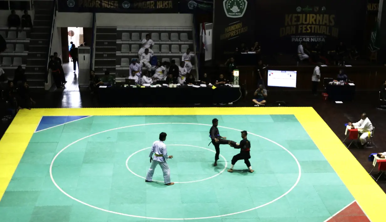Pendekar Pagar Nusa saat bertarung dalam Kejurnas dan Festival III Pencak Silat di Padepokan Pencak Silat, TMII, Jakarta, Sabtu (4/1). Kejuaraan ini diikuti ratusan pendekar silat Pagar Nusa dari seluruh Indonesia. (Bola.com/Yoppy Renato)