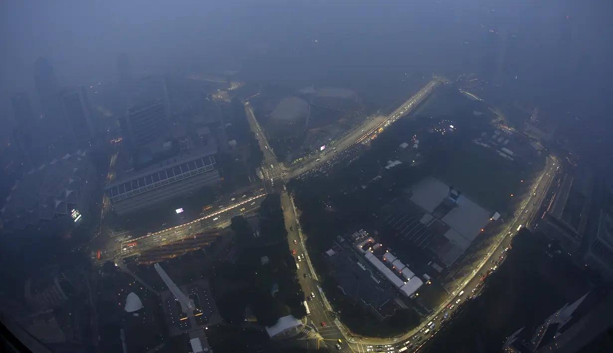 Pandangan dari atas Sirkuit Marina Bay Street yang tertutup asap tebal, Singapura, Rabu (16/9/2015). Kabut asap yang menyelimuti sirkuit tak menyurutkan penyelenggara untuk tetap melangsungkan F1 Grand Prix Singapura. (REUTERS/Edgar Su)